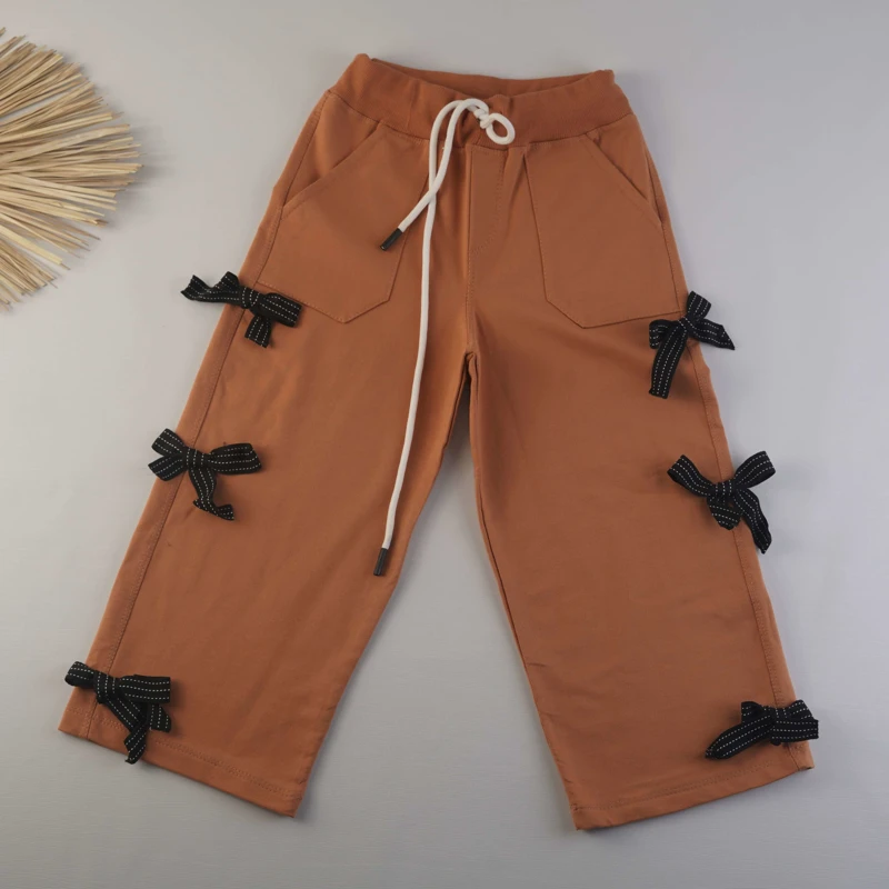 شلوار بگ دخترانه نارنجی جیب‌دار با طرح پاپیون توری